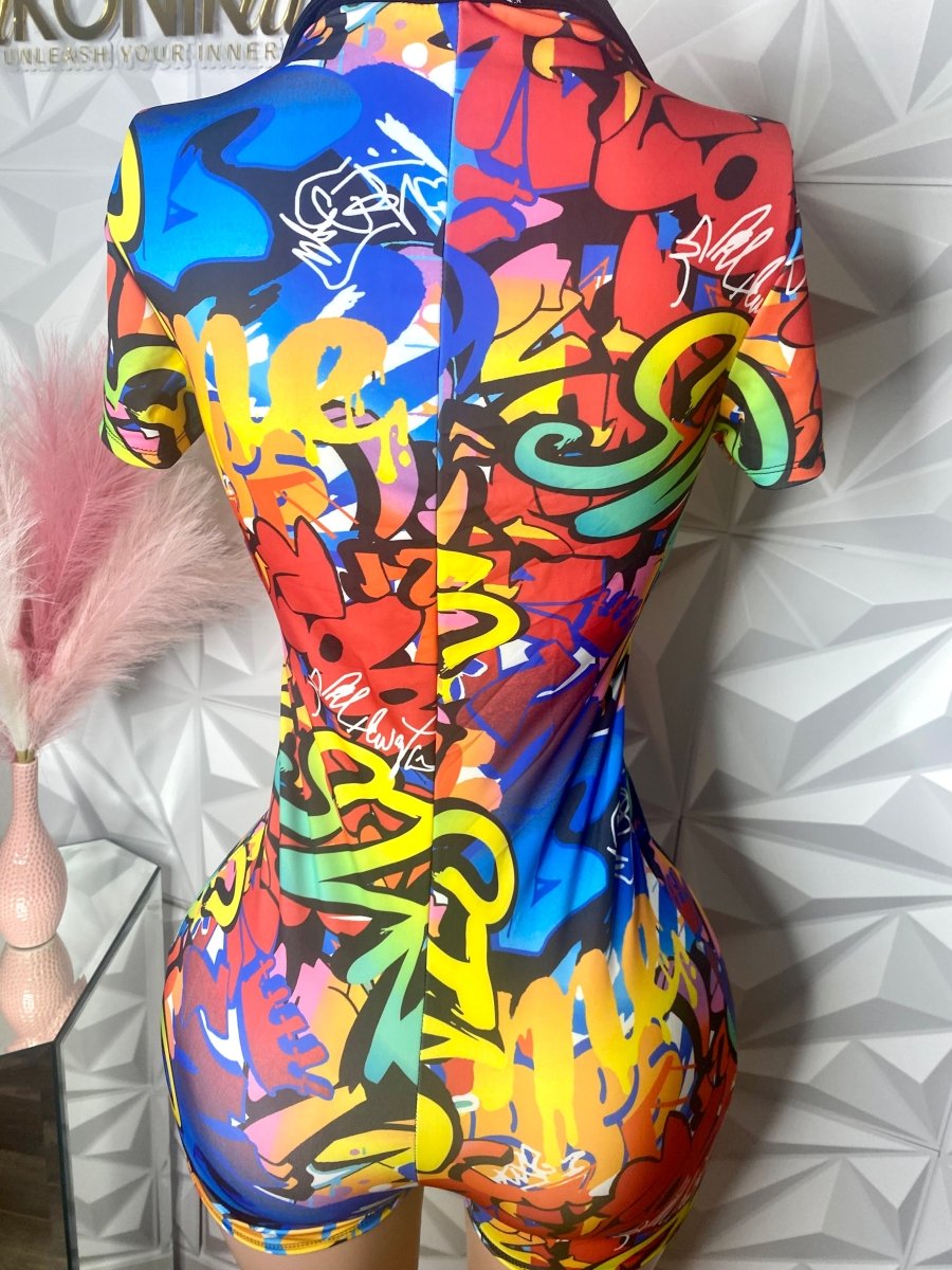 Colorful romper with hip hop streetwear inspired design pattern on textured background.