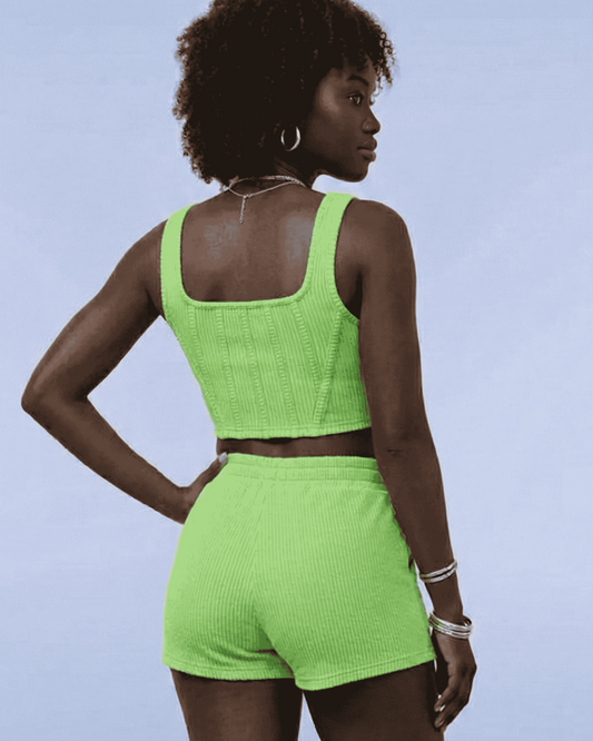 Person wearing a bright green sports outfit on a light blue background