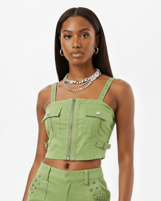 Woman wearing a green outfit and silver jewelry with a white background