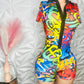Colorful graffiti-style romper on a mannequin against a textured wall with 'Ikonik Idoll' branding.