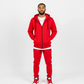 Red men’s tech fleece tracksuit from Ikonik Kingz, black zipper details, studio photo on white background.