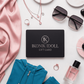 Ikonik Idoll gift card surrounded by fashion items on a white surface