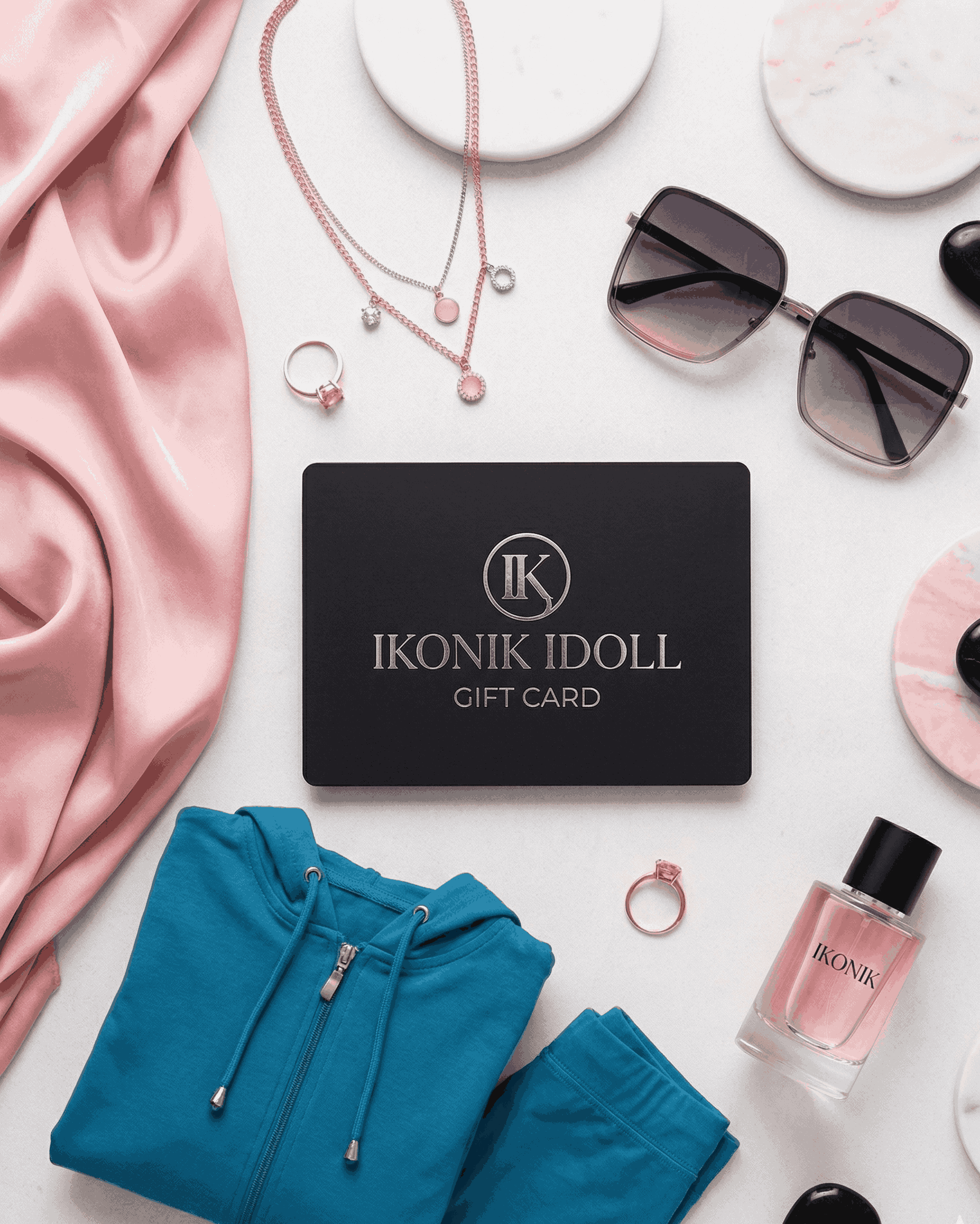Ikonik Idoll gift card surrounded by fashion items on a white surface