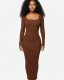 Woman wearing a brown ribbed dress on a white background