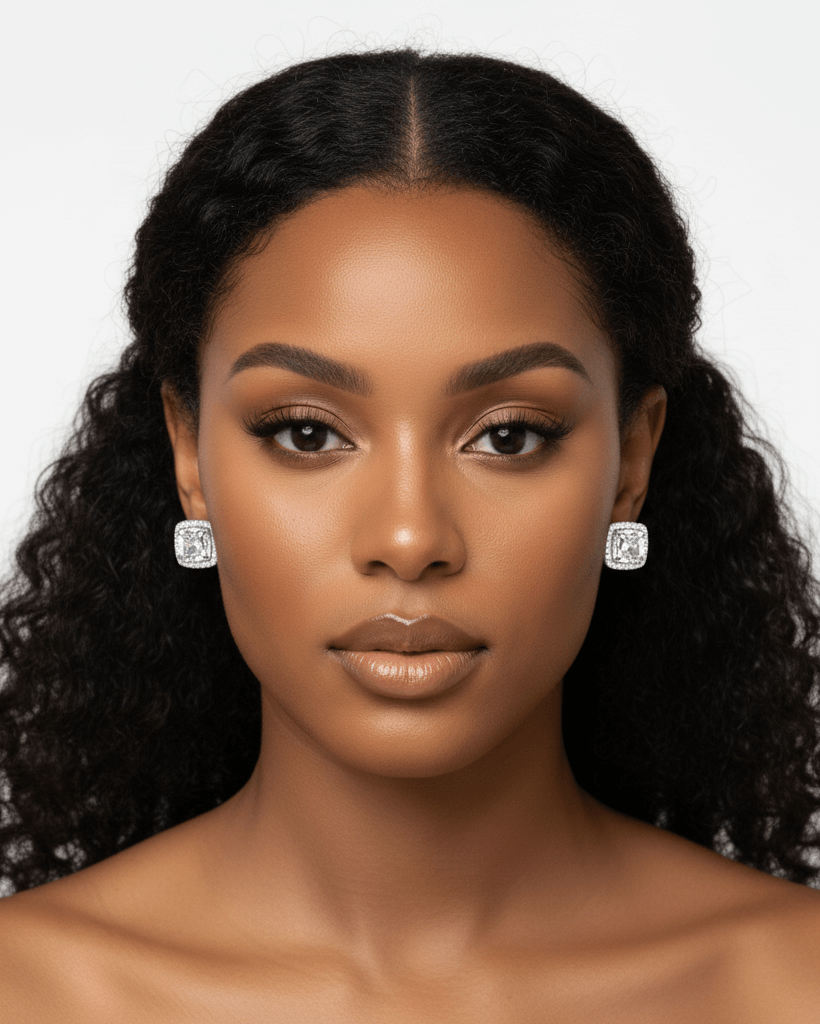 Woman wearing diamond earrings against a white background