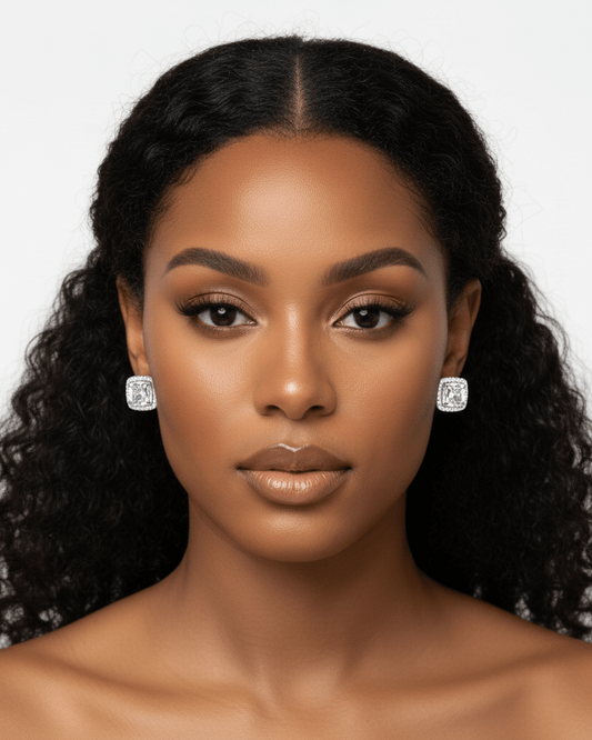 Woman wearing diamond earrings against a white background