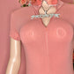 Mannequin wearing a pink outfit with sunglasses and a necklace against a pink background
