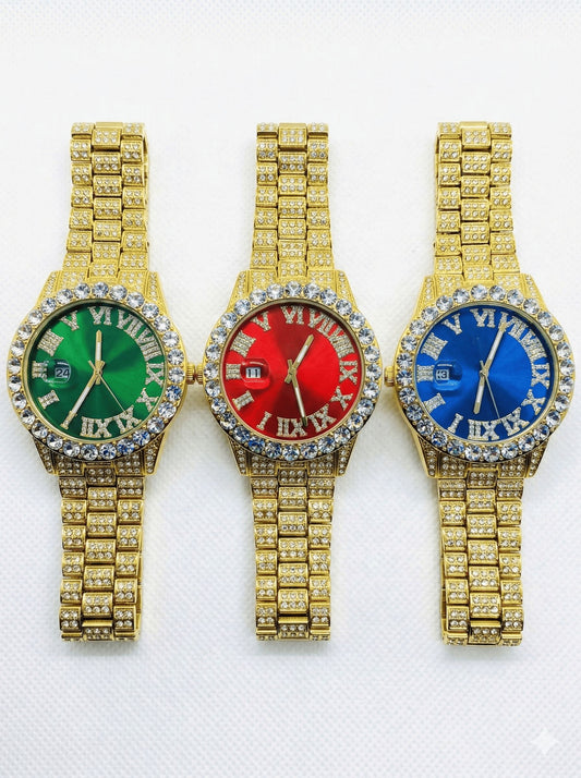 Three gold-iced out watches with green, red, and blue faces on a white background