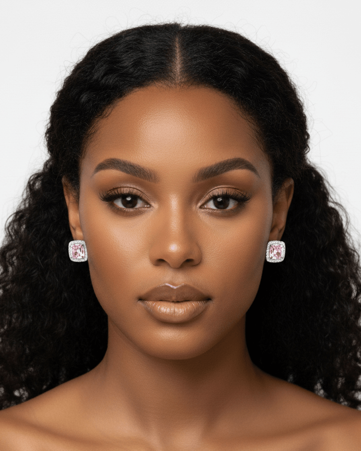 Woman with pink and silver diamond chunky earrings against a plain background