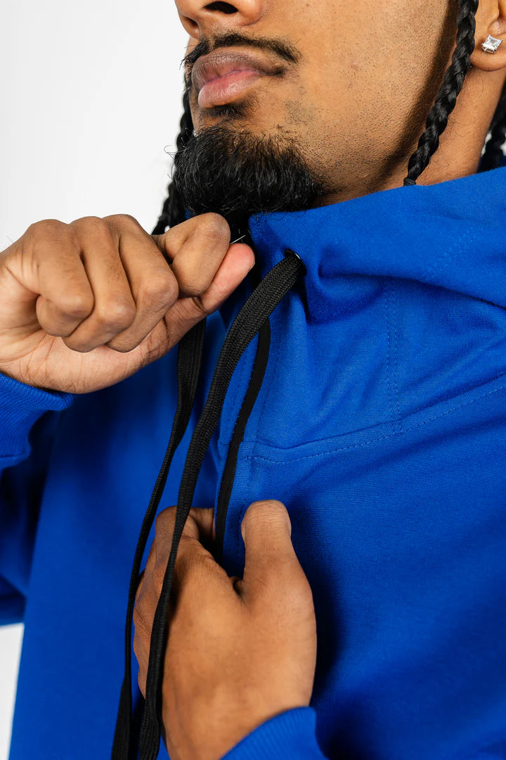 Close-up of royal blue men’s tech fleece hoodie showing drawstrings and premium fleece texture.