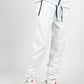 White men’s tech fleece tracksuit with black zipper details, styled with white and red Jordans on white studio background.