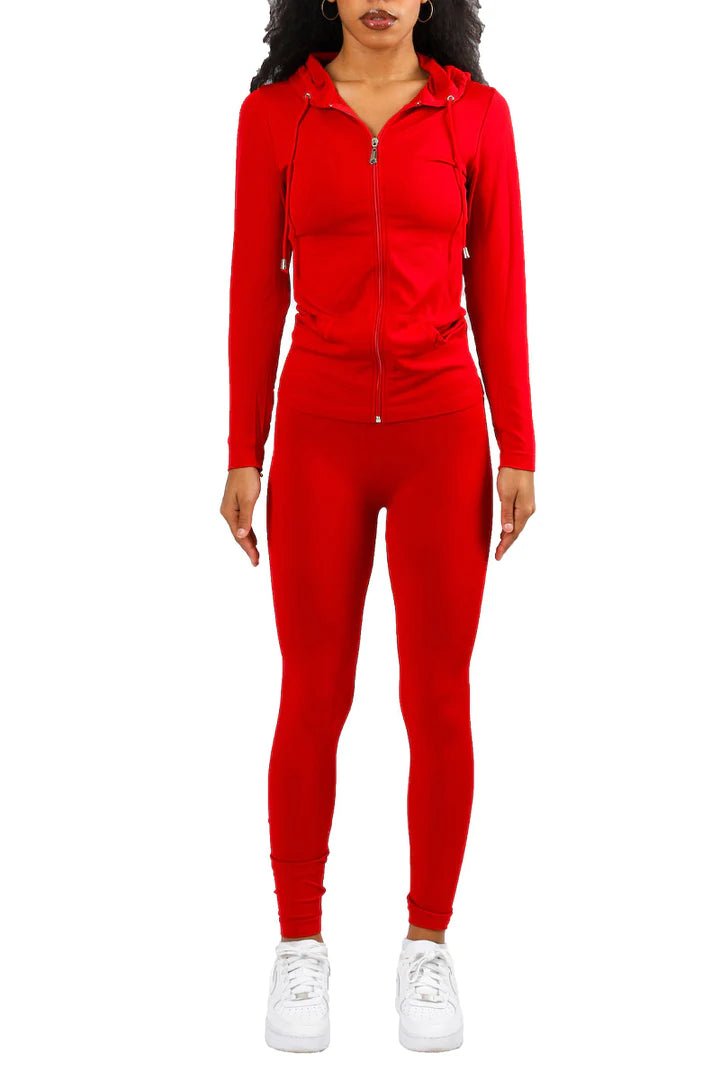 Model wearing bright red long sleeve tracksuit set with sneakers for sporty streetwear look
