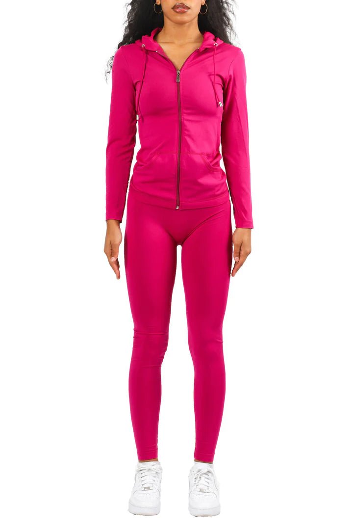 Woman in magenta pink lounge set with sneakers styled for casual streetwear outfit idea on white background
