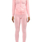Curvy woman in pink two-piece legging set with long sleeve top styled for running errands or lounging
