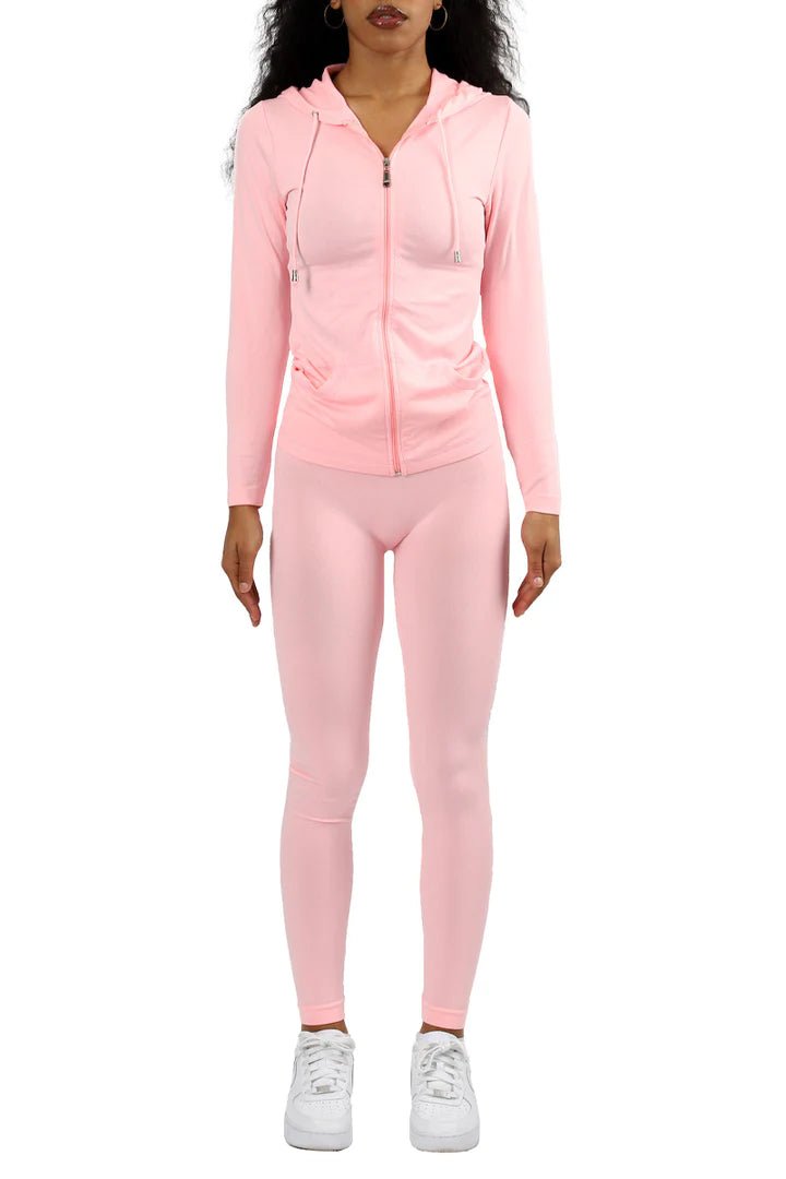 Curvy woman in pink two-piece legging set with long sleeve top styled for running errands or lounging