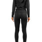 Athletic model wearing black matching legging set with black jacket hoodie and white sneakers for everyday casual wear