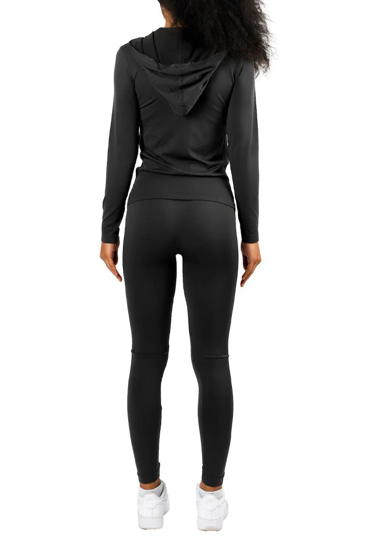 Athletic model wearing black matching legging set with black jacket hoodie and white sneakers for everyday casual wear