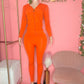 Mannequin in orange fall outfit set with high-waist leggings and stretch top with zip up hoodie jacket 