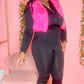 Plus-size woman wearing black matching set with pink puffer vest, pink slouch socks, and black UGG slides for cozy fall and winter outfit