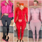 Three mannequins wearing black, red, and pink matching sets styled with cropped puffer vest, sunglasses, crossbody bags, and boots