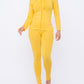 Athleisure outfit idea featuring matching jacket yellow legging set on confident plus-size woman