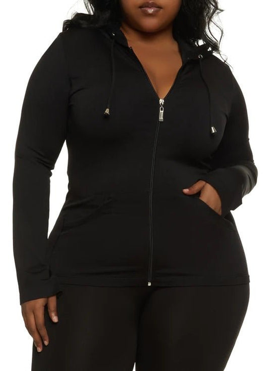 Plus-size woman in black long sleeve legging set styled for comfy airport outfit or errands
