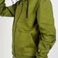 Close-up of olive green tech fleece material showing pocket zipper and fabric texture.