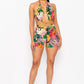 Woman wearing a colorful printed romper outfit on vacation
