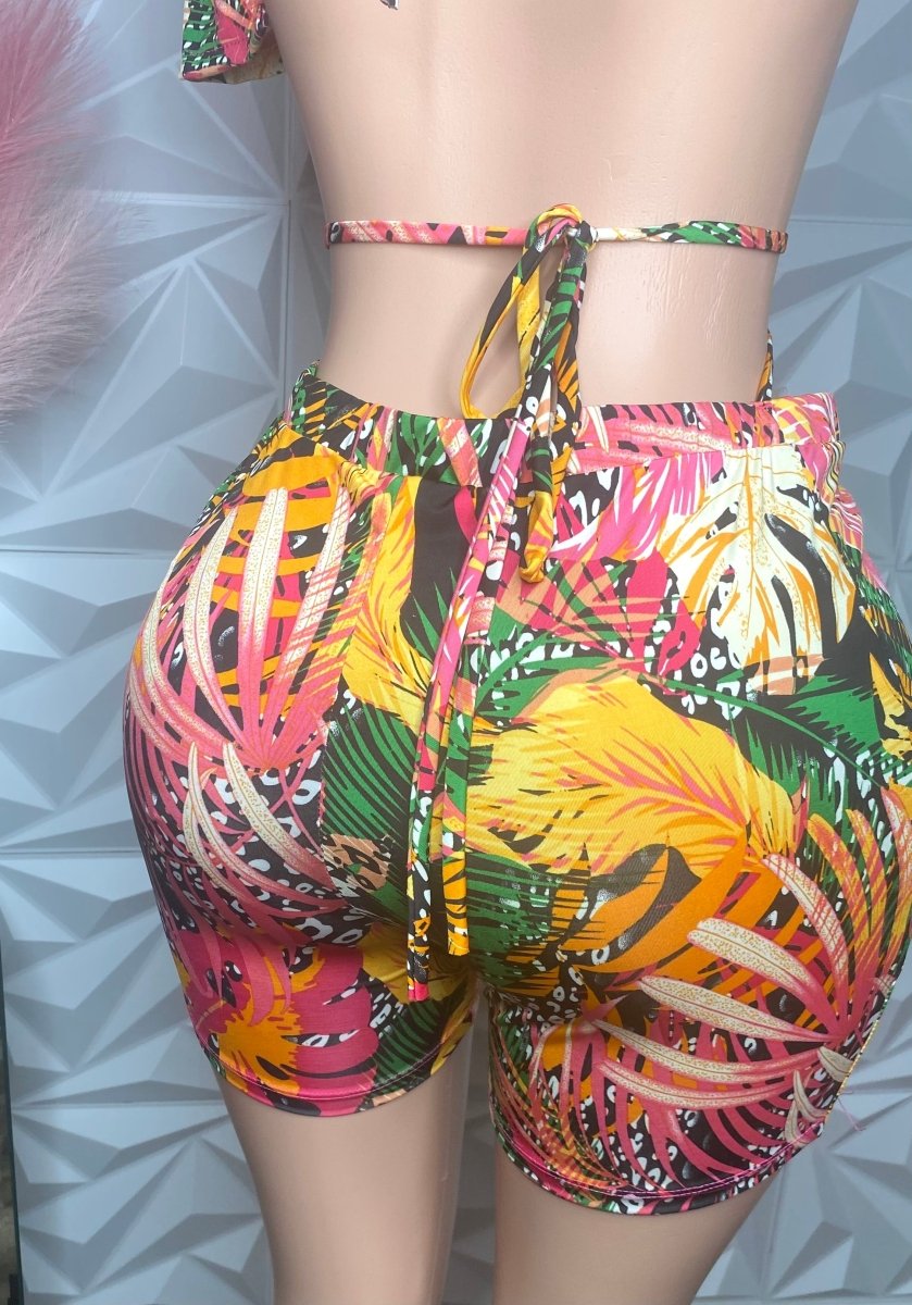 Colorful tropical print shorts on a neutral background