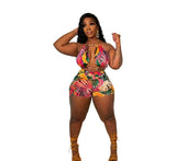Curvy woman in bright colored printed romper with yellow heels